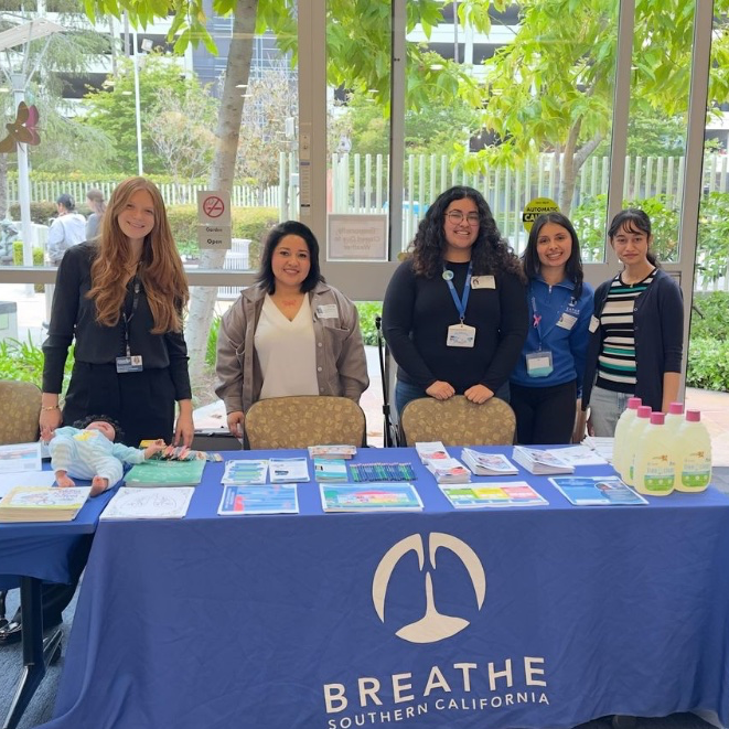 Breathe Southern California team at community health event with educational materials on asthma and allergies and Certified air filters