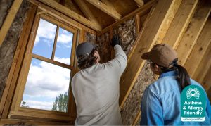 Contractors installing Knauf insulation, Certified Asthma & Allergy Friendly®, supporting better indoor air quality.