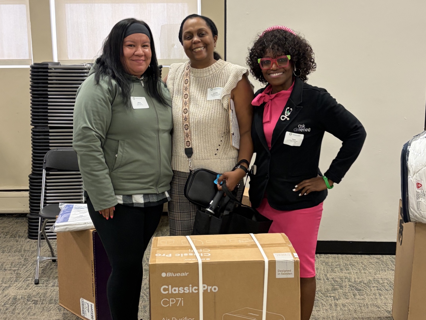 Rachelle Paul-Brutus, Executive Director of the Chicago Asthma Consortium, with Certified partner product donations including the Blueair air purifier at the 2026 Community Health Worker Educational Forum.