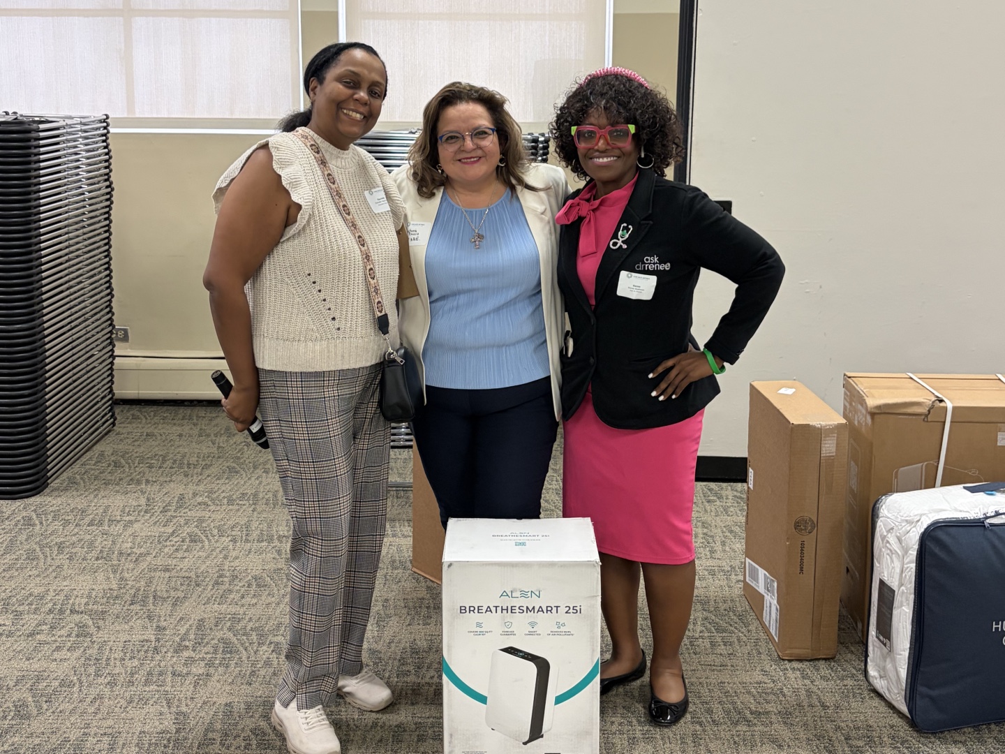 Rachelle Paul-Brutus, Executive Director of the Chicago Asthma Consortium, with Certified partner product donations including the Alen BreatheSmart 25i air purifier at the 2026 Community Health Worker Educational Forum.