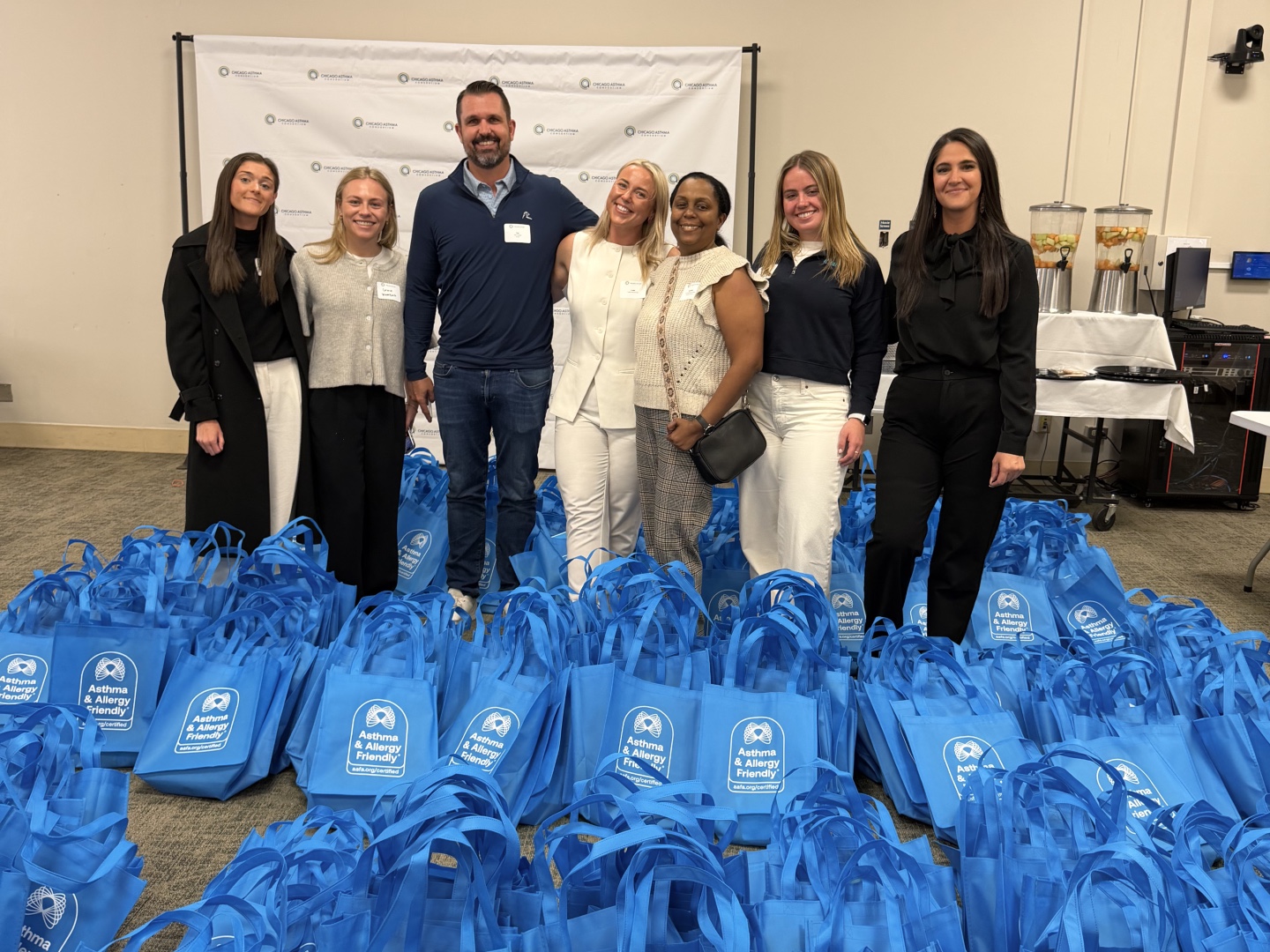 Representatives from Knauf North America, the Chicago Asthma Consortium, and the Asthma & Allergy Friendly Certification Program with 300 packed Resource Tote Bags at the 2026 Community Health Worker Educational Forum, Sinai Chicago.