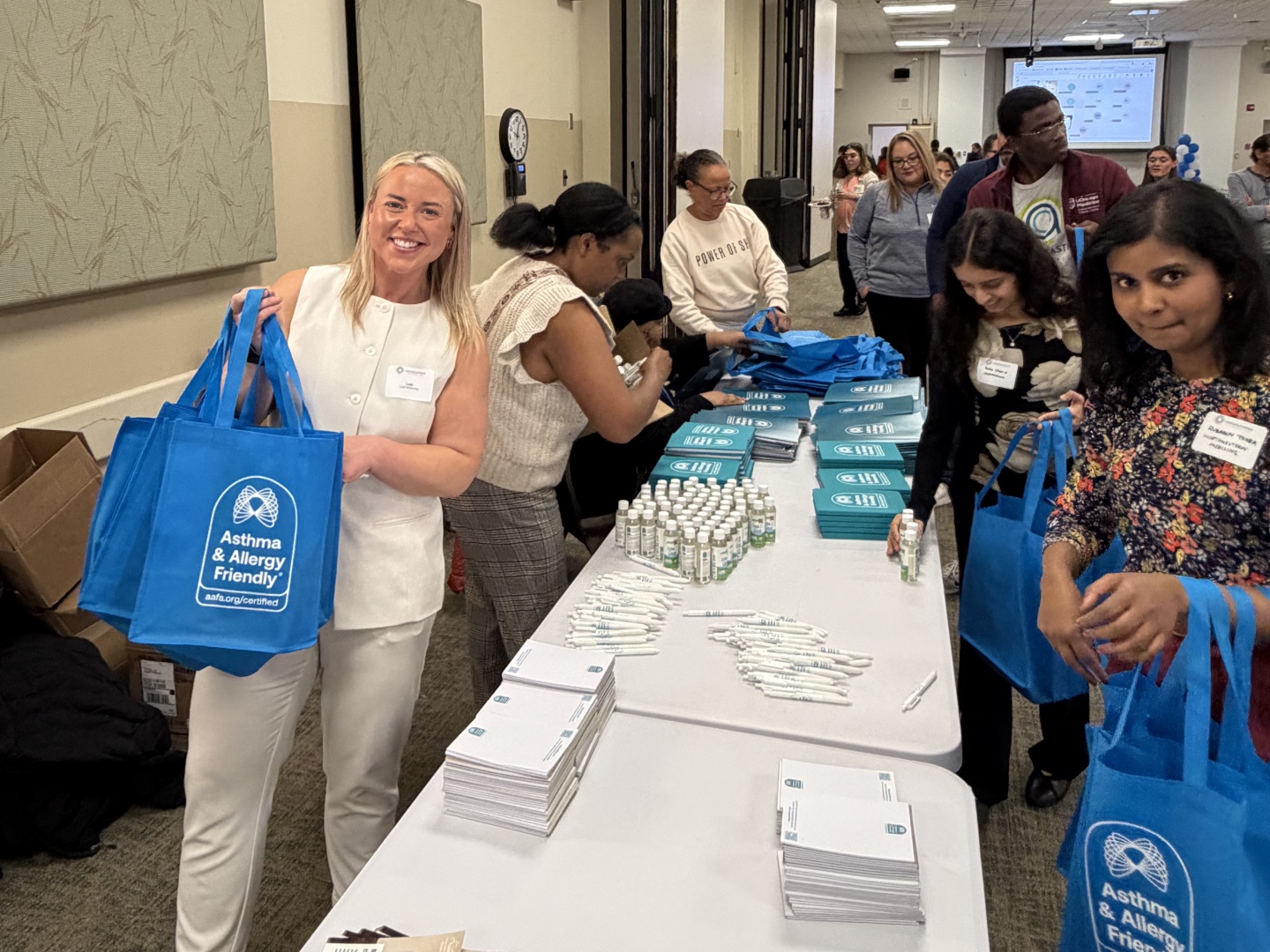 Leah McInerney of the Asthma & Allergy Friendly Certification Program and forum attendees packing resource tote bags at the 2026 Chicago Asthma Consortium Community Health Worker Educational Forum at Sinai Chicago.